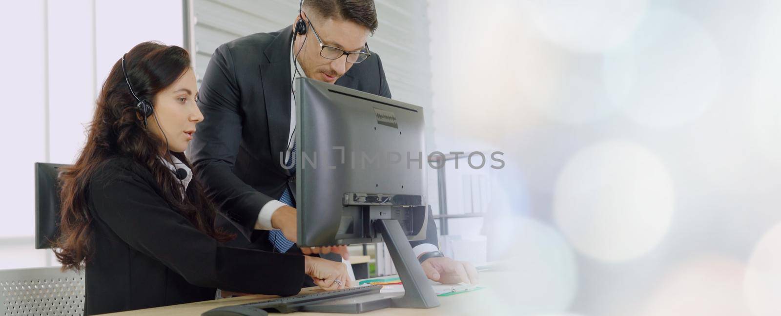 Business people wearing headset working in office broaden view by biancoblue