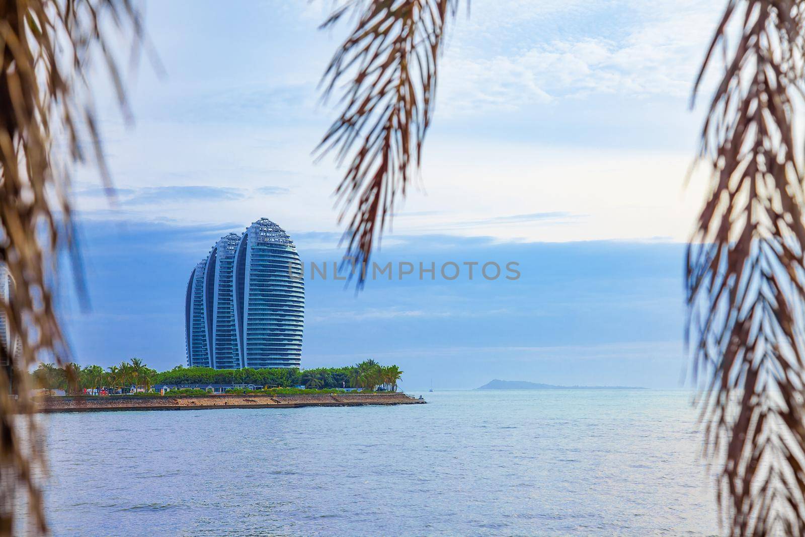 Travel tropical coastline lanscape with sea, foliage and palm leaves