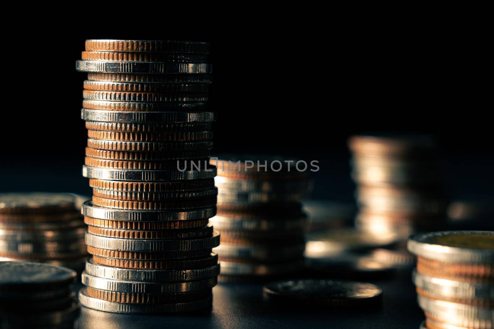 Pile of gold coins stack in finance treasury deposit bank account for saving by biancoblue