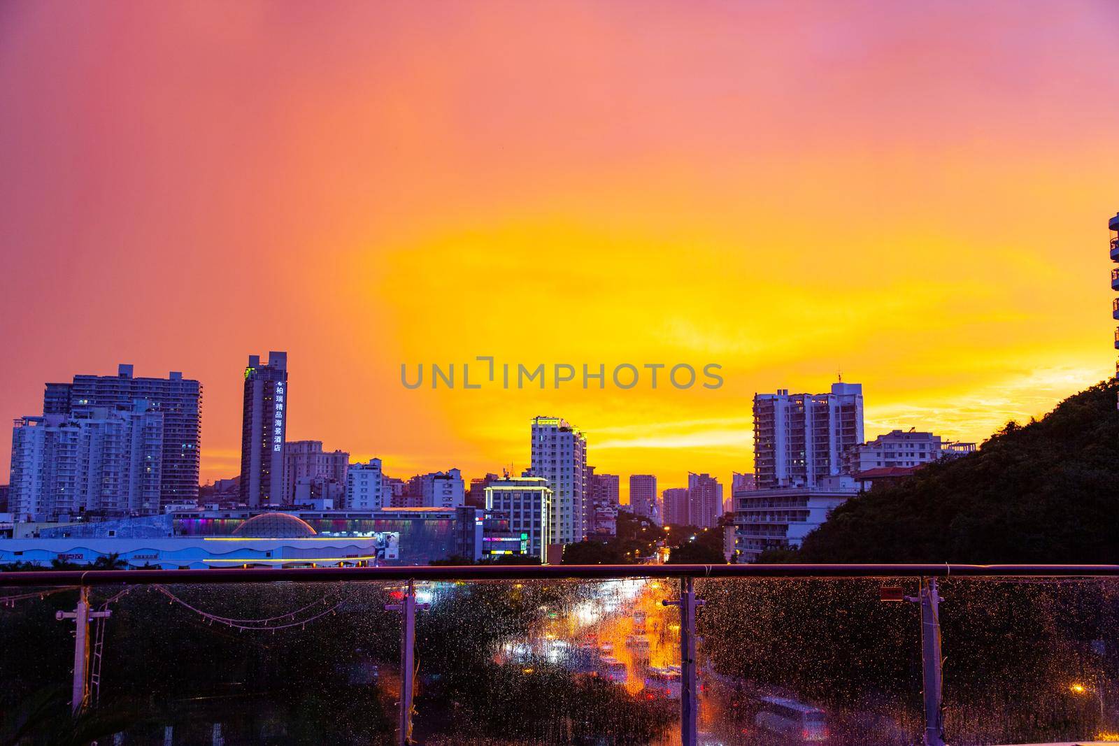 Hainan Sanya City with rain and bright orange sky by kisika