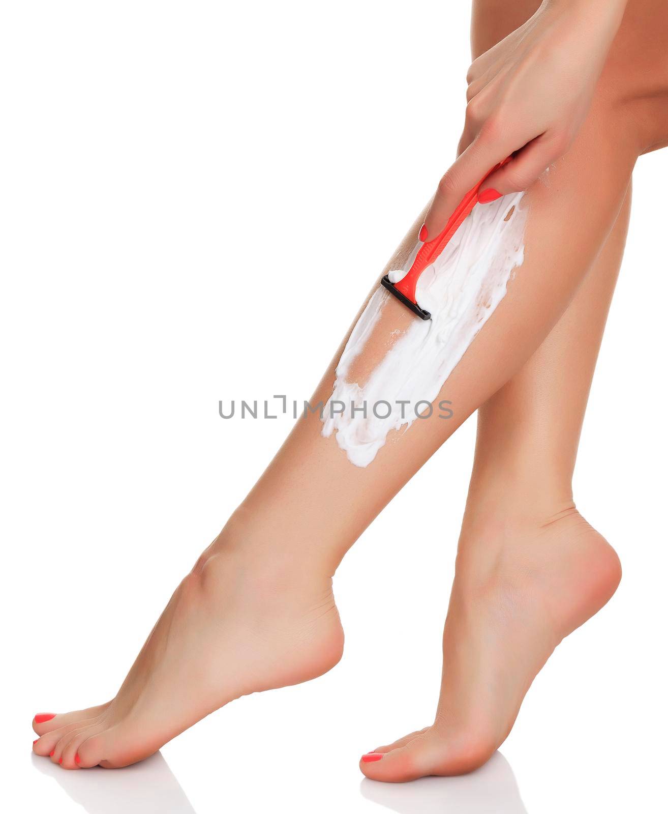 woman shaves her legs, isolated on white, copyspace