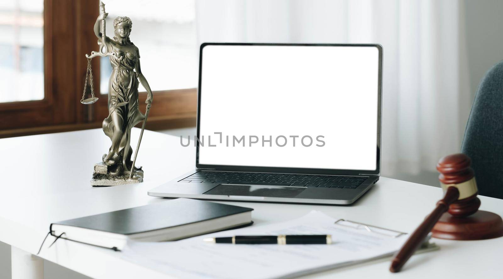 Workspace of lawyer with laptop blank white screen and law wooden gavel,legal book and brass scale of judge. lawyer and law ,judiciary and legislature courtroom legal concept. by wichayada