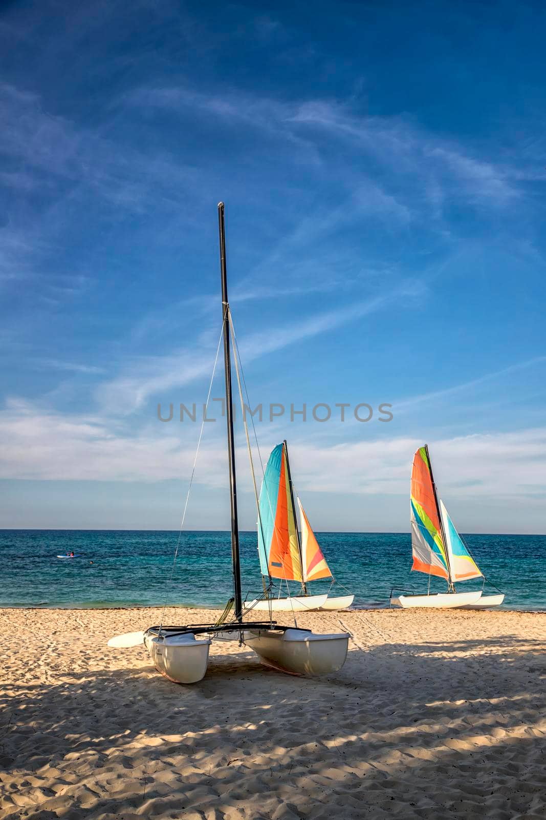 Colorful sail catamarans on the beach. The tropical resort area with the most beautiful beaches. 