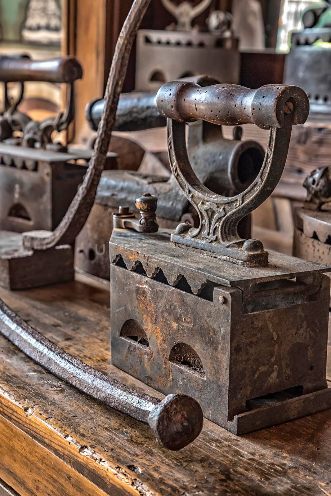 Ancient vintage irons for the clothes ironing. Vertical view by EdVal