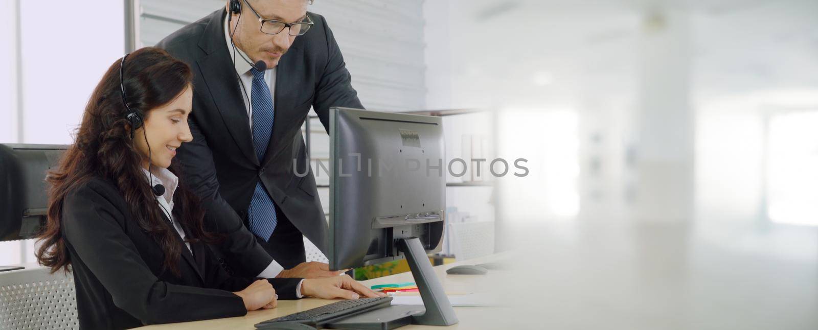 Business people wearing headset working in office to support remote customer or colleague. Call center, telemarketing, customer support agent provide service in broaden view .