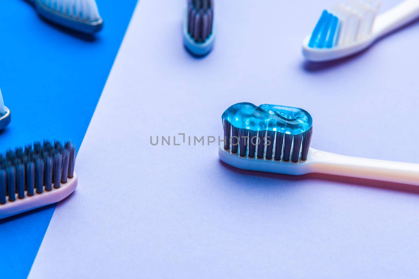 Flat lay composition with manual toothbrushes on color background, close up by Fabrikasimf