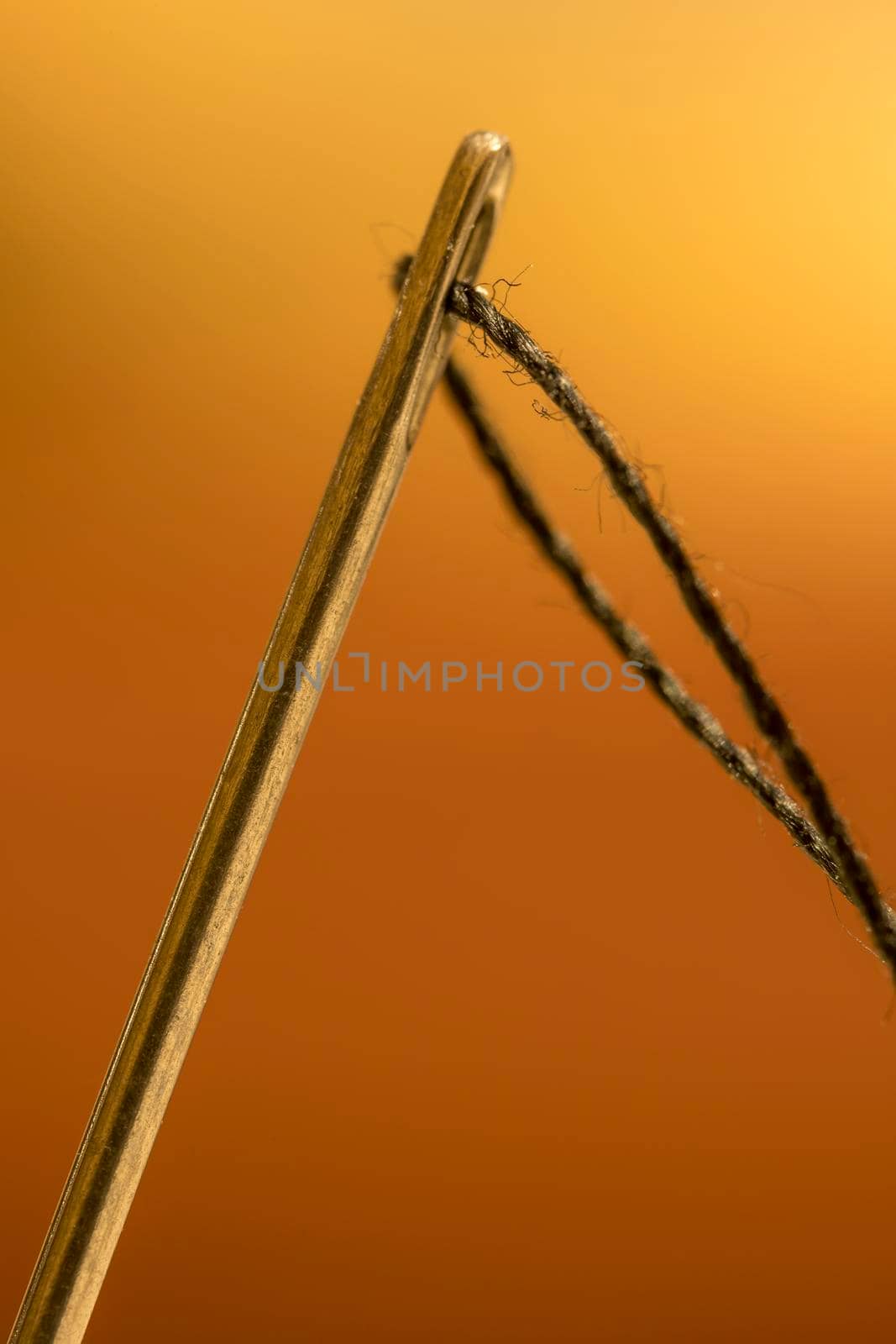 macro shot of needle with eye black thread. Close up 