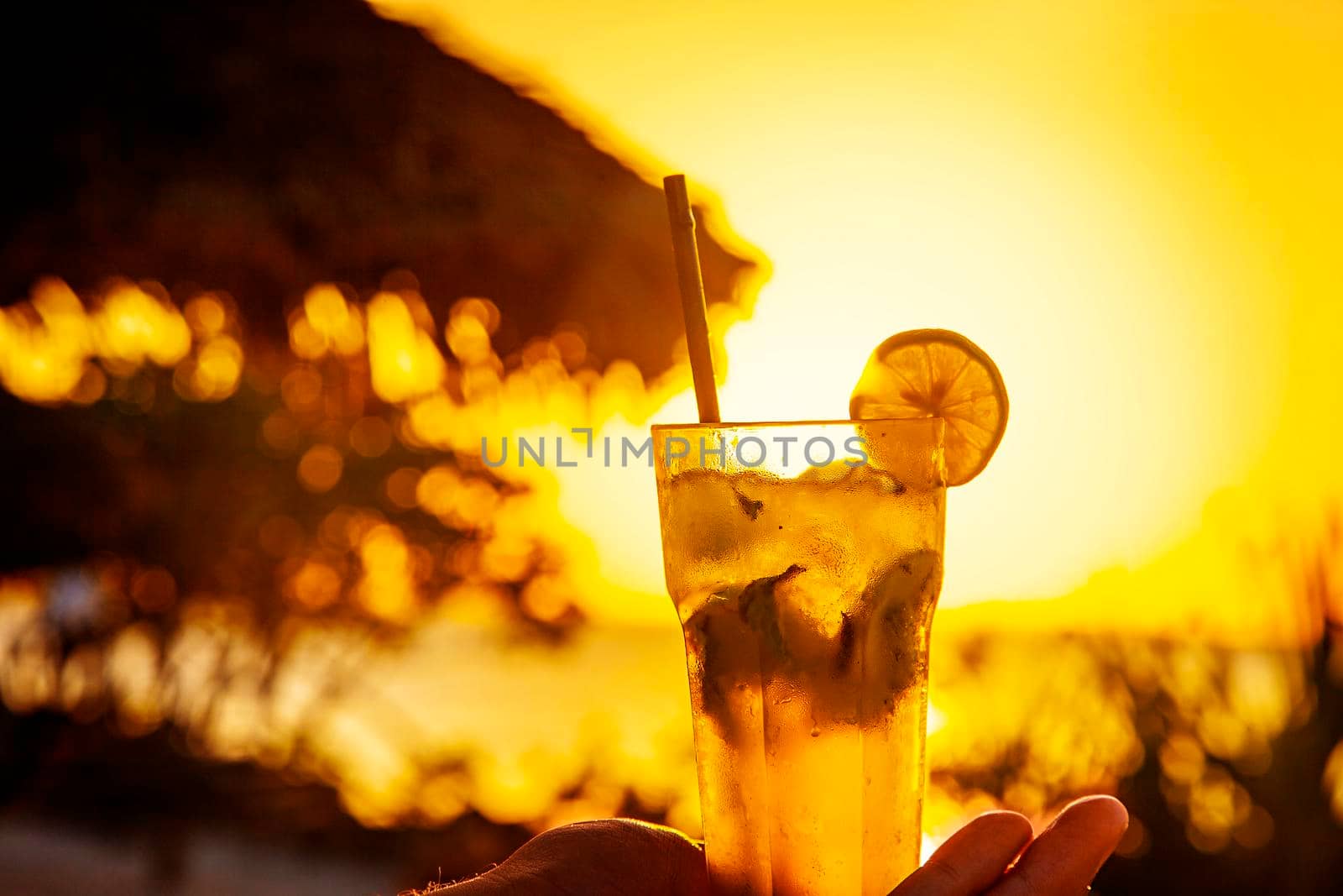Tropical orange sunset relax view with fresh beverage by kisika