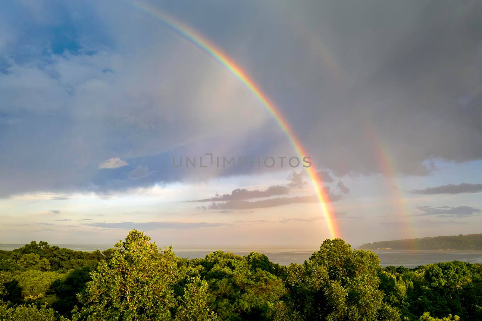 Stunning two big rainbows after the rain over the sea