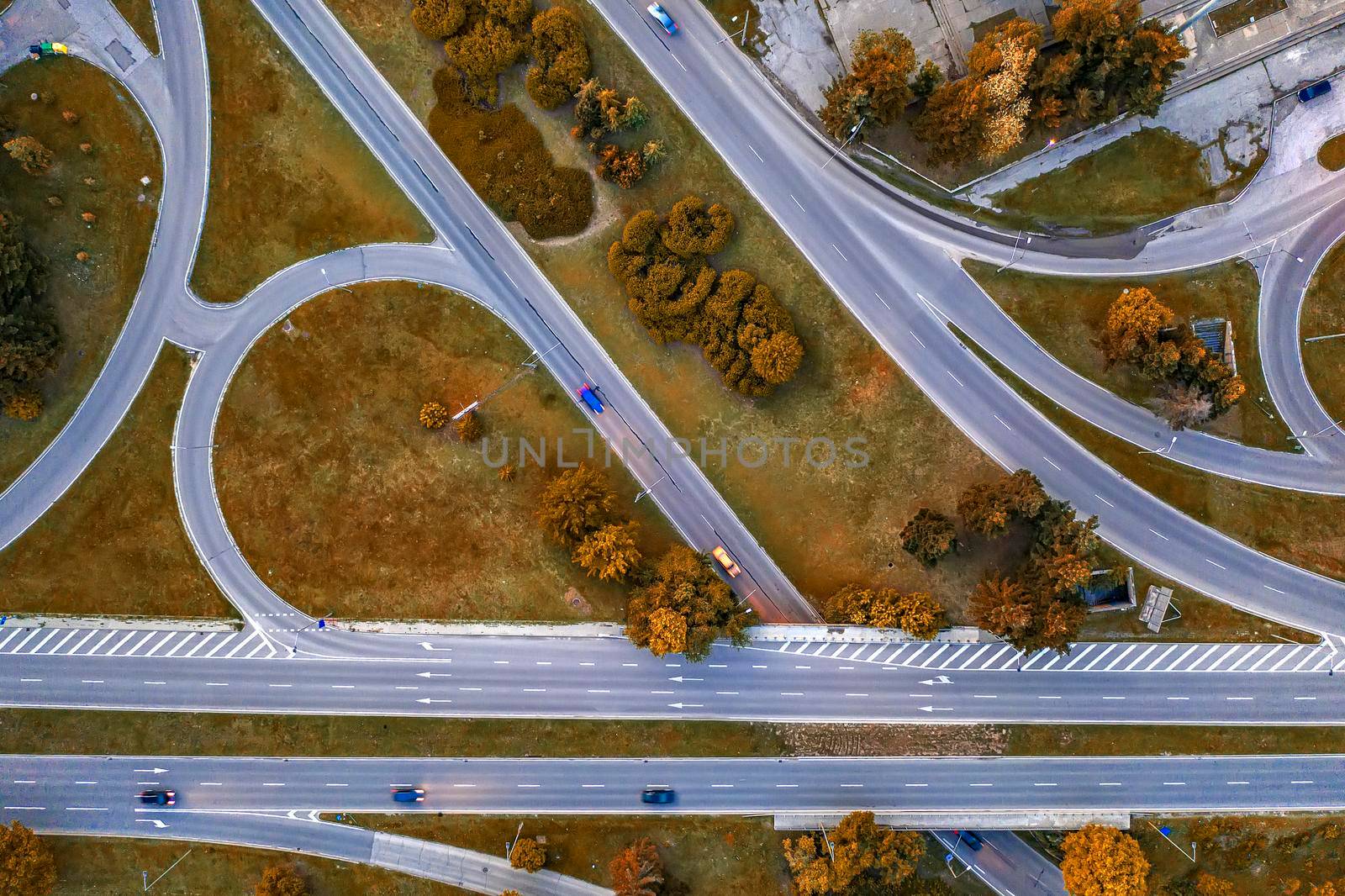 Aerial top view of the modern highway road intersection in autumn. Drone photography.