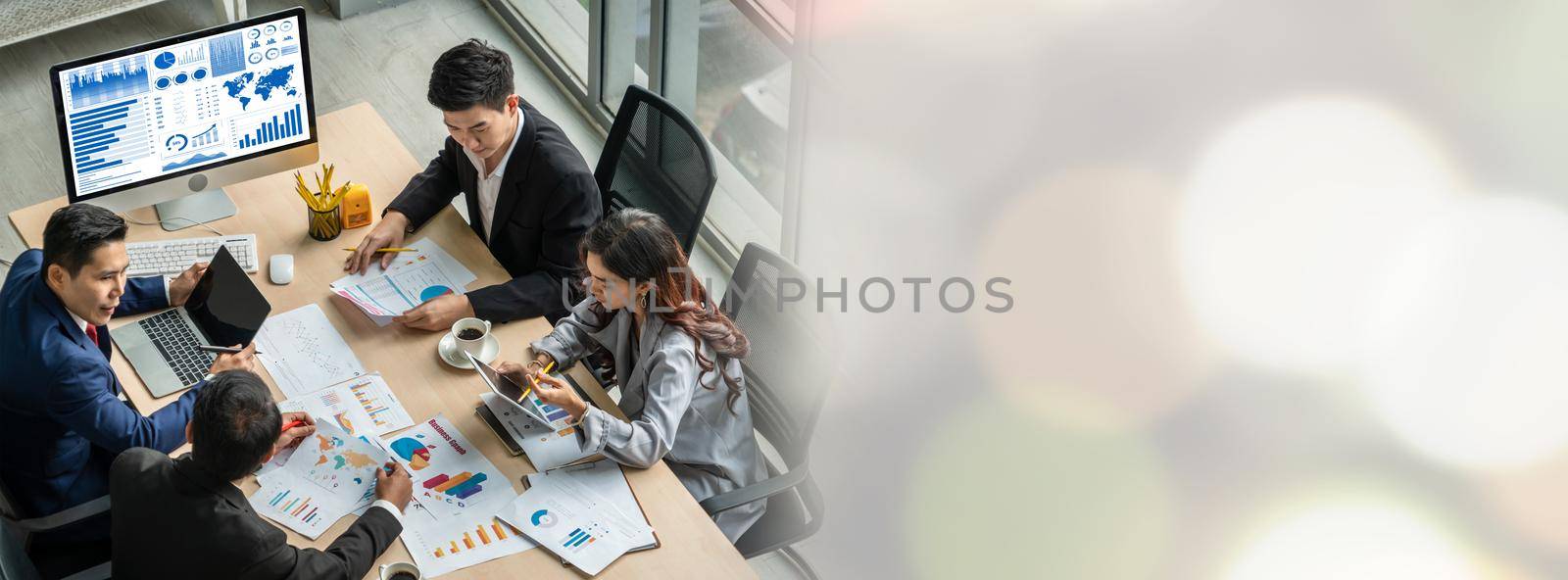 Business people group meeting shot from top widen view in office . Profession businesswomen, businessmen and office workers working in team conference with project planning document on meeting table .