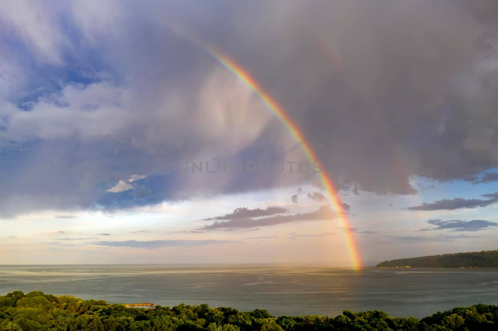 Stunning big rainbow after the rain over the sea