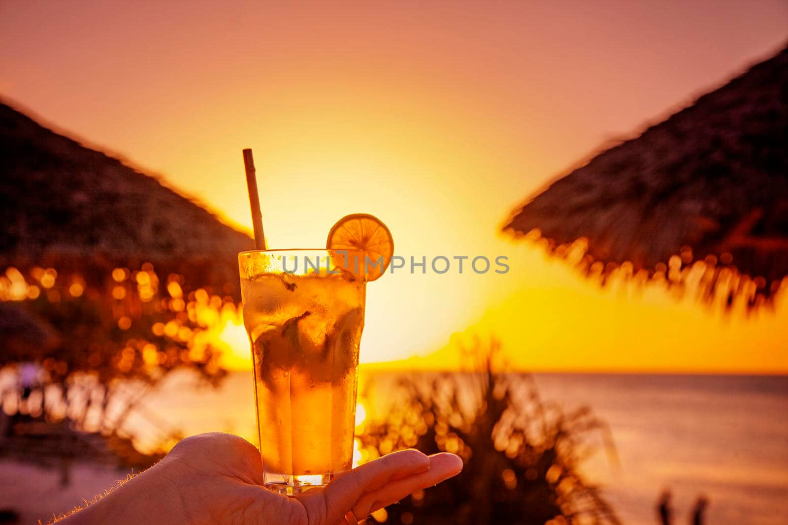 Tropical orange sunset relax view with fresh beverage by kisika