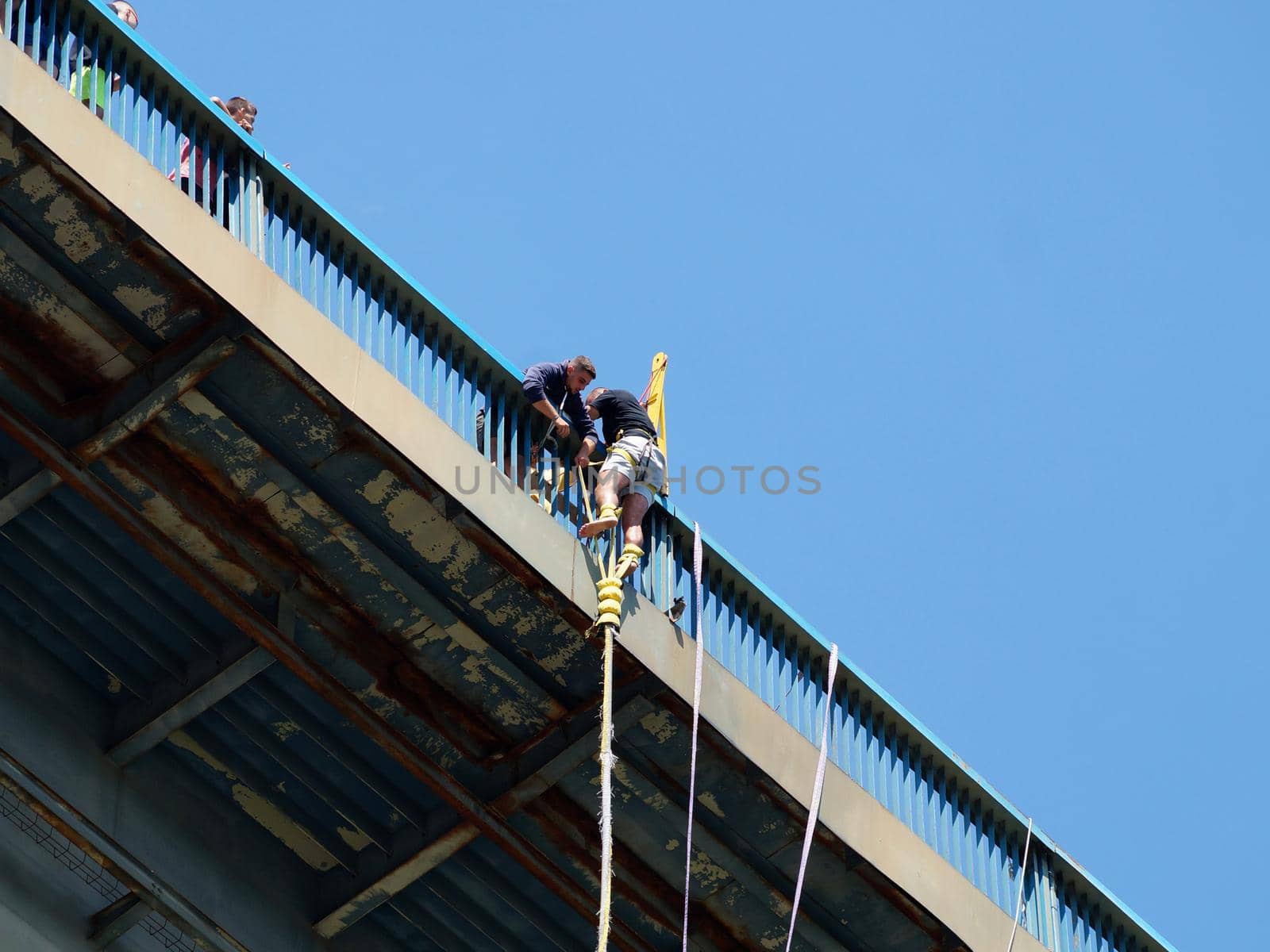 Varna, Bulgaria - August, 28, 2021: a man climbs a bridge after a bungee jump