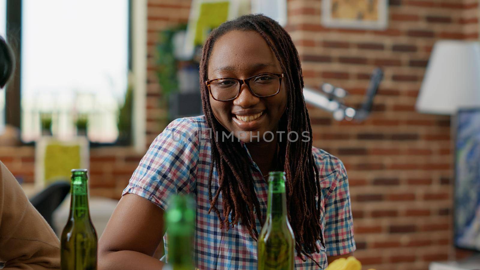 Portrait of happy woman looking at people playing chess game by DCStudio