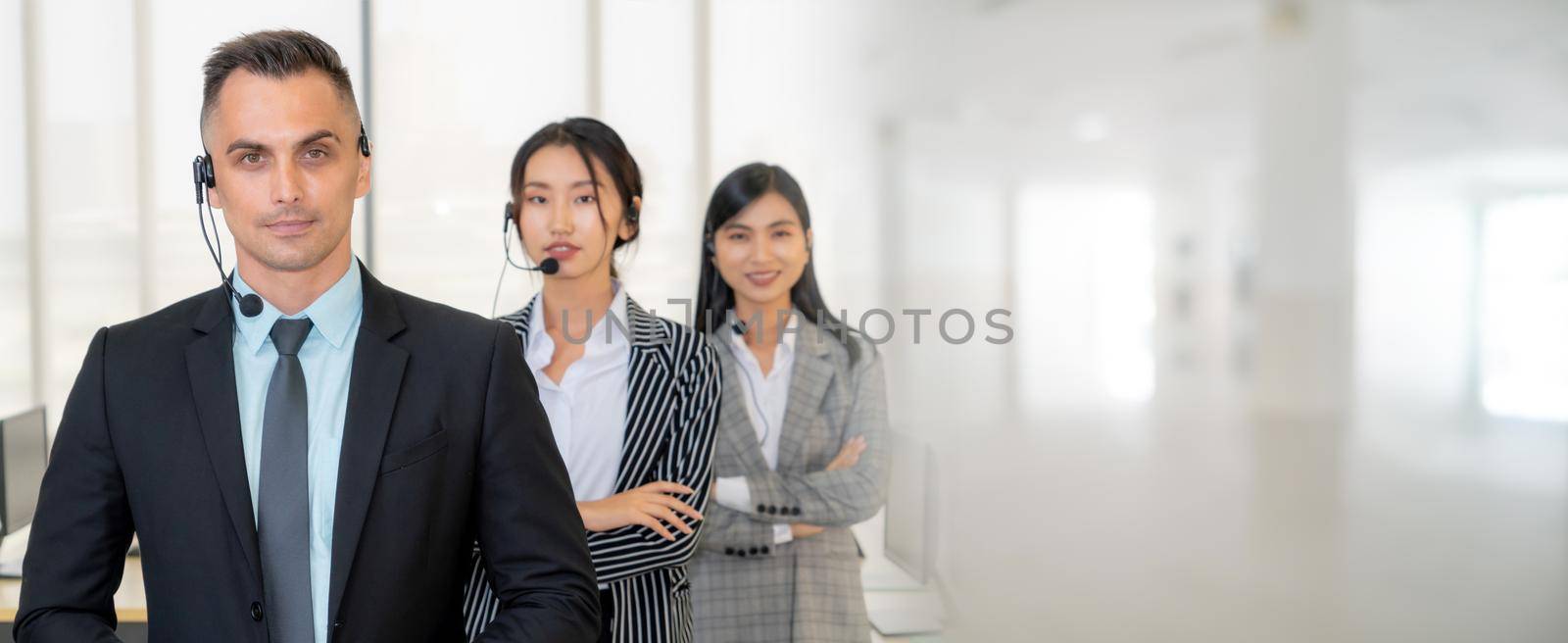 Business people wearing headset working in office to support remote customer or colleague. Call center, telemarketing, customer support agent provide service in broaden view .