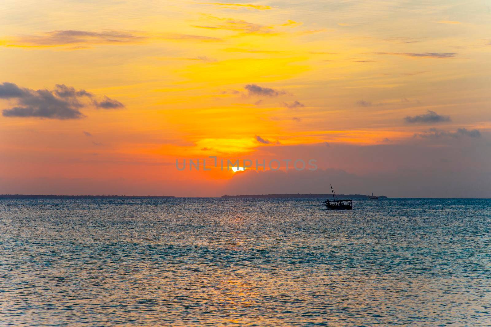 Tropical orange sunset with clouds and blue sky by kisika