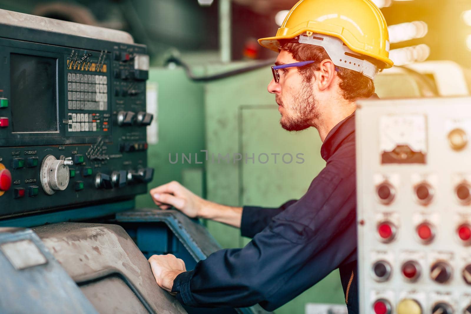 young profession technician engineer operate heavy machine to automated CNC in factory. by qualitystocks