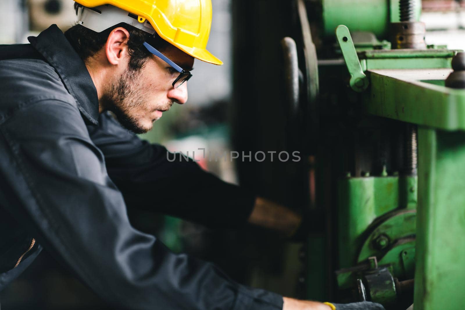 Young American worker intend to work in a heavy industrial factory.