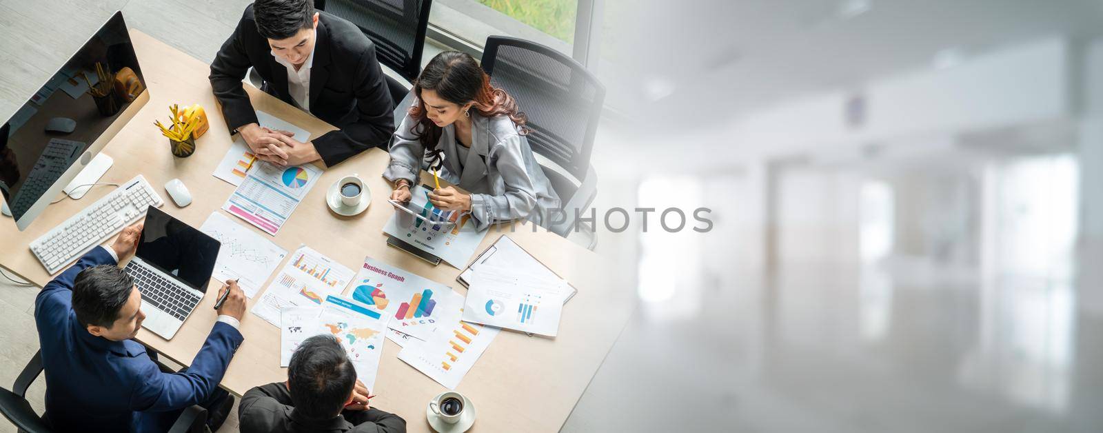 Business people group meeting shot from top widen view in office . Profession businesswomen, businessmen and office workers working in team conference with project planning document on meeting table .