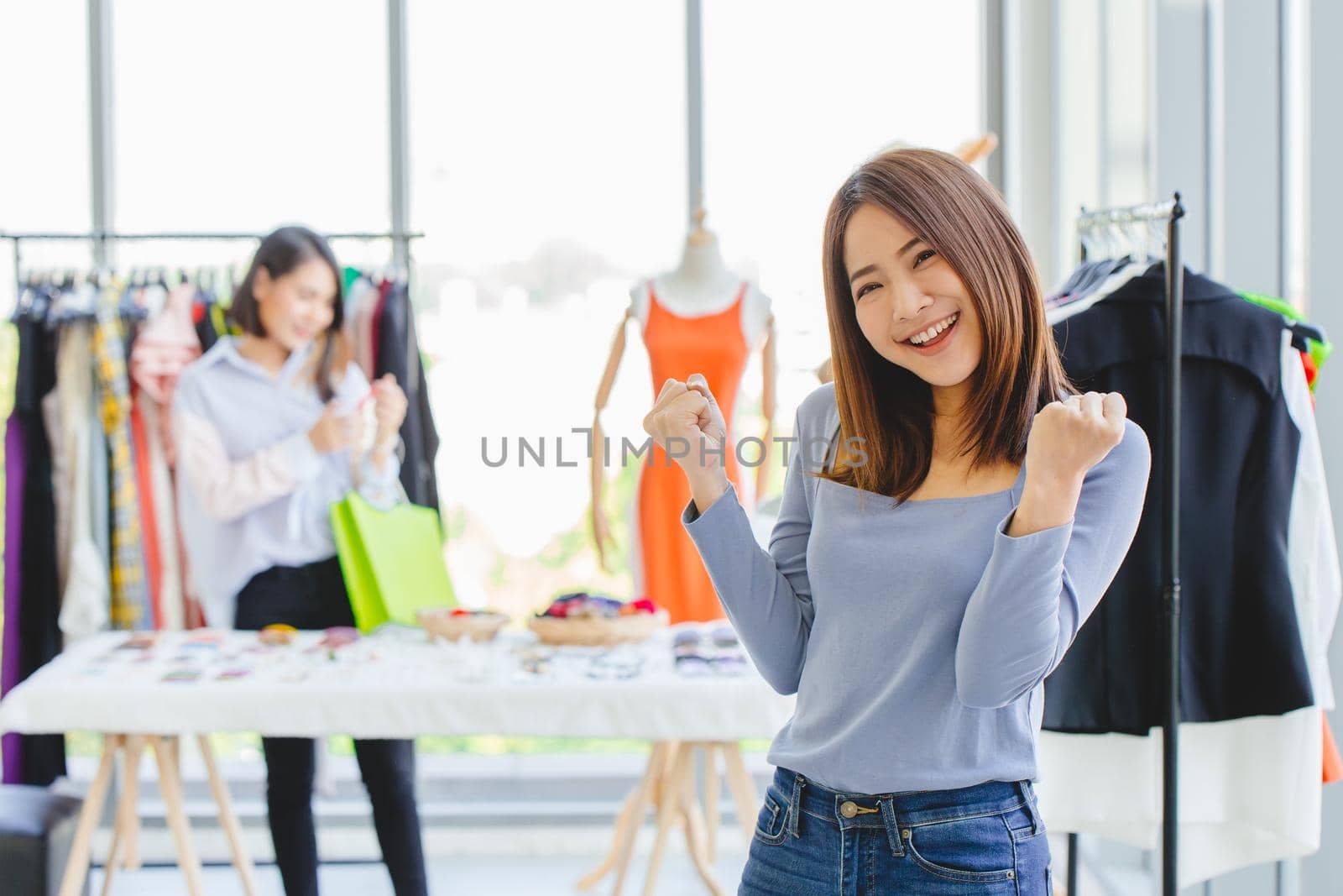 Young Asian girl teen SME clothing shop owner happy smile gladful with opening new business promotion and customer. by qualitystocks