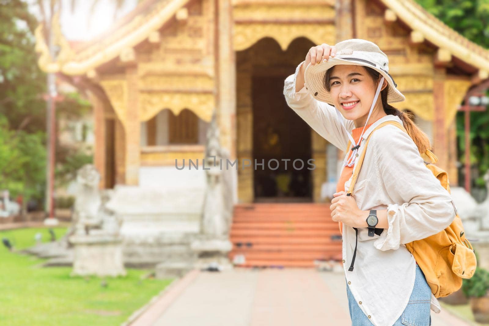 Asian girl teen enjoy smiling travel at Thai temple in Chiang Mai Northern province of Thailand
