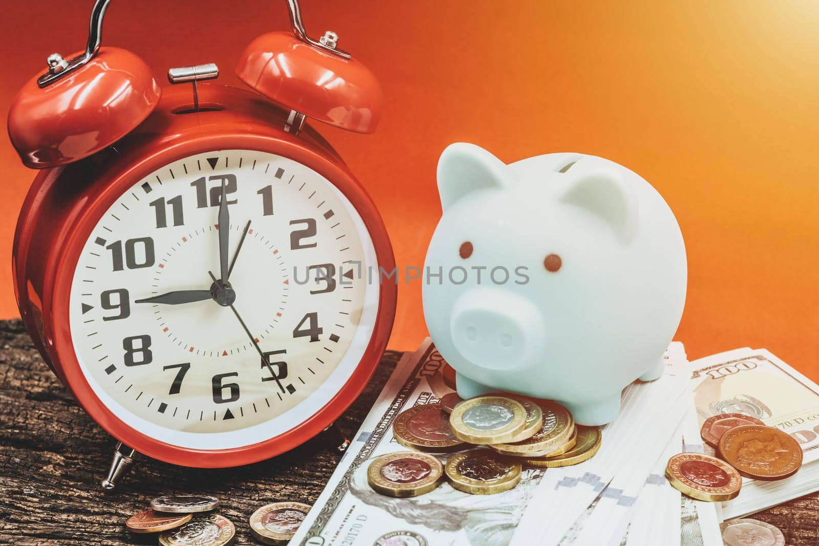 Money Times wealth clock concept, Time to saving money coin with piggy bank for financial business income. by qualitystocks
