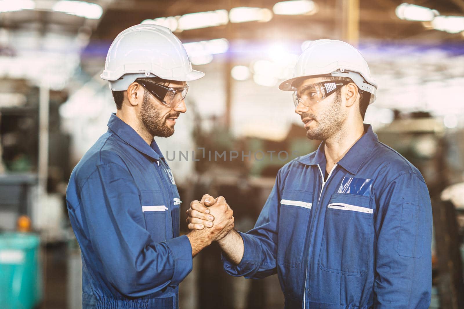 Factory engineer team worker join unity hand in hand together. by qualitystocks