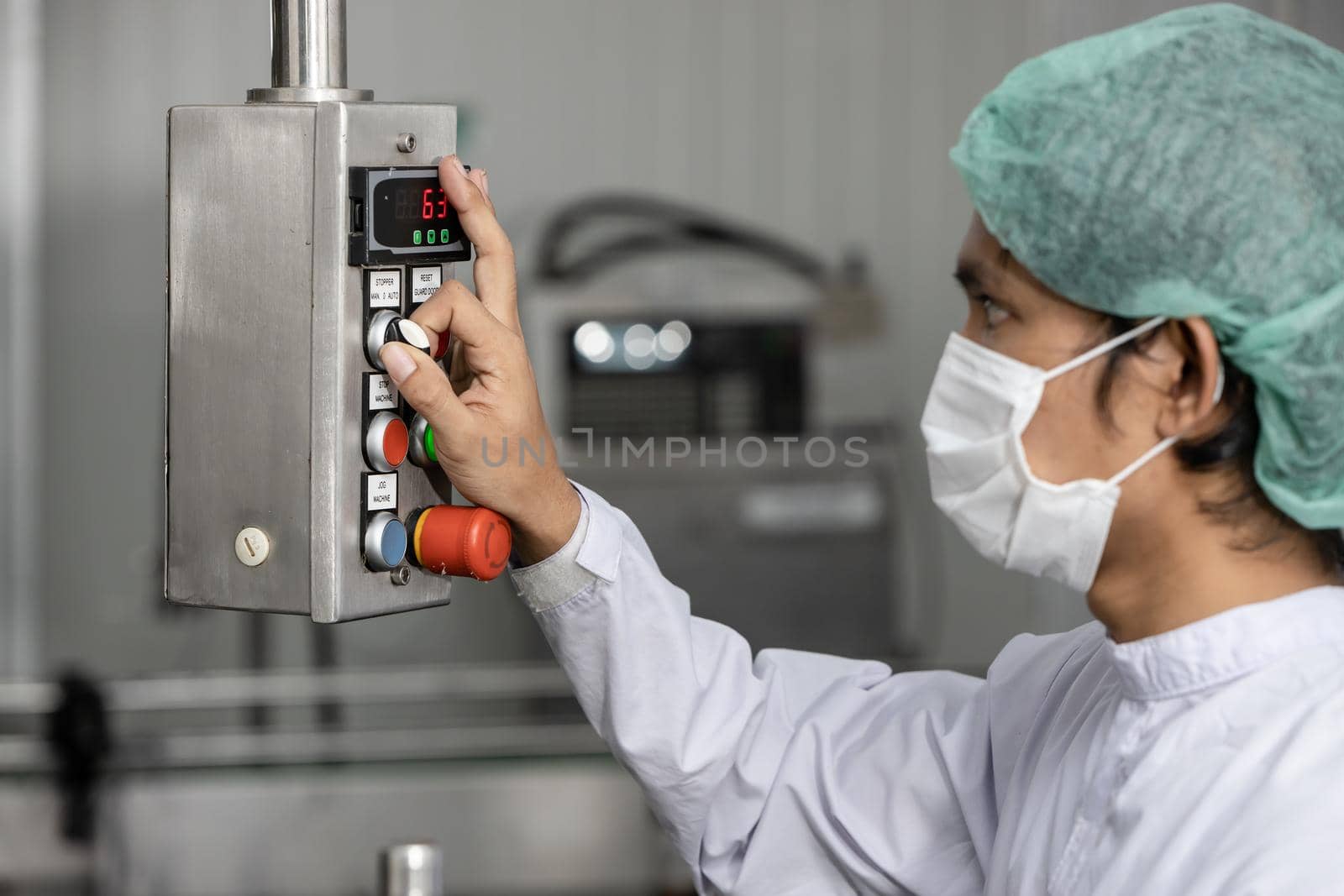 Staff workers working operate control machine in hygiene food factory.