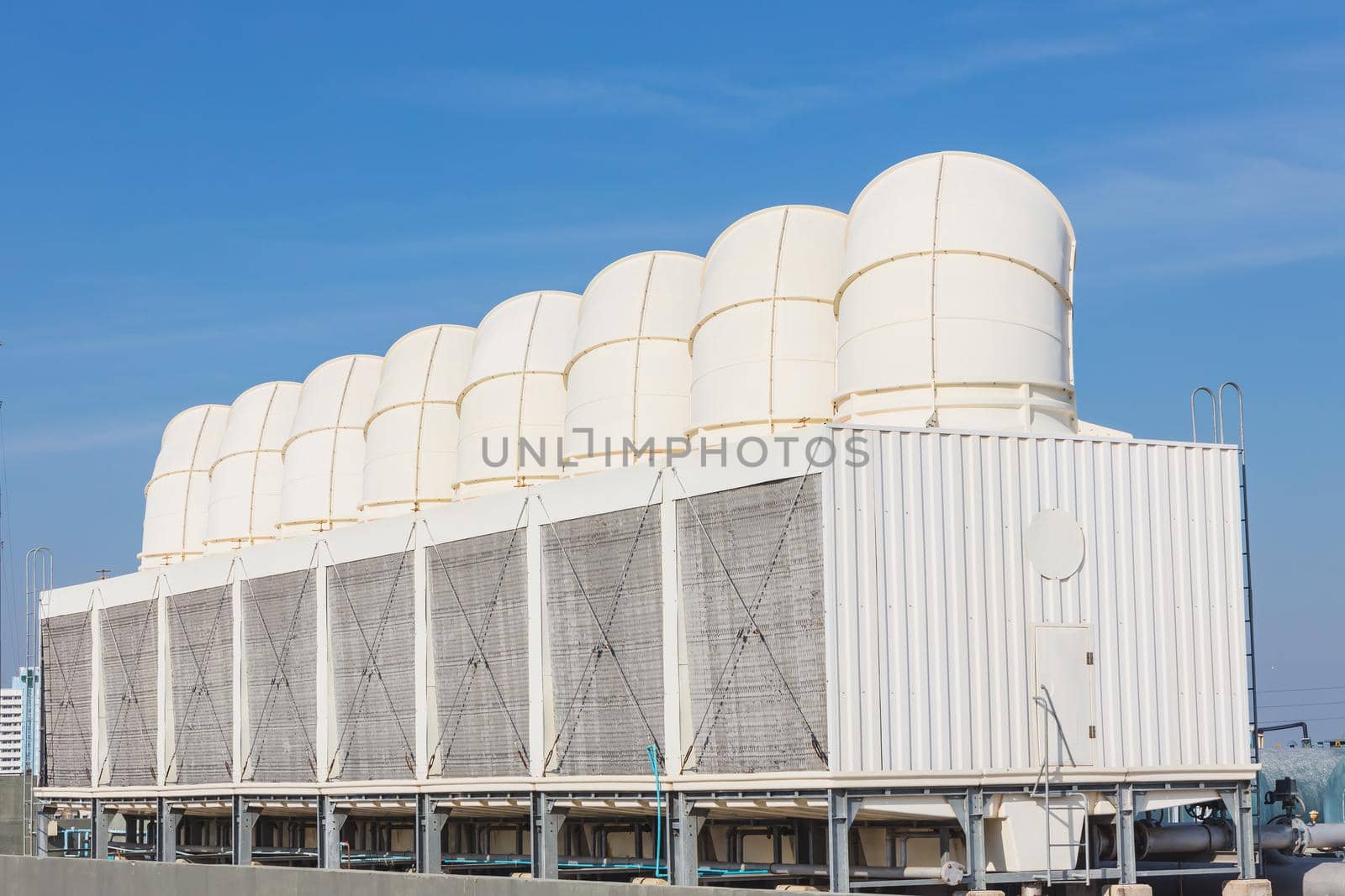 Air cooling tower for HVAC chilling units at building rooftop outdoor blue sky. by qualitystocks