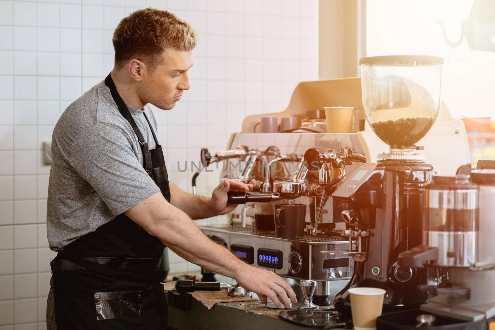 barista man making italian espresso coffee with espresso machine at the cafe