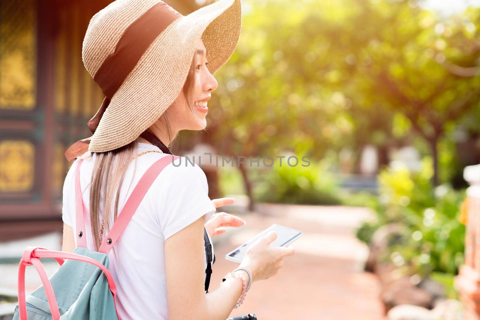 girl teen travel happy smile, Asian women tourist walking with hat backpack bag and camera by qualitystocks