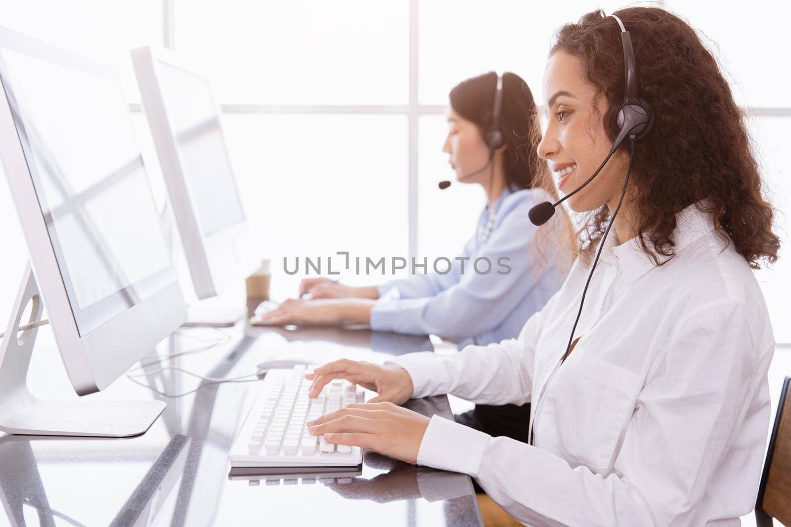 Callcenter people working calling for helpdesk hotline or Telesale agent, Customer support happy working with smile in office.