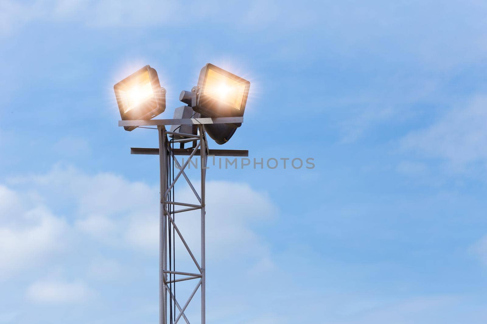 LED outdoors flood light, spot light on at high post for large area park ground security by qualitystocks