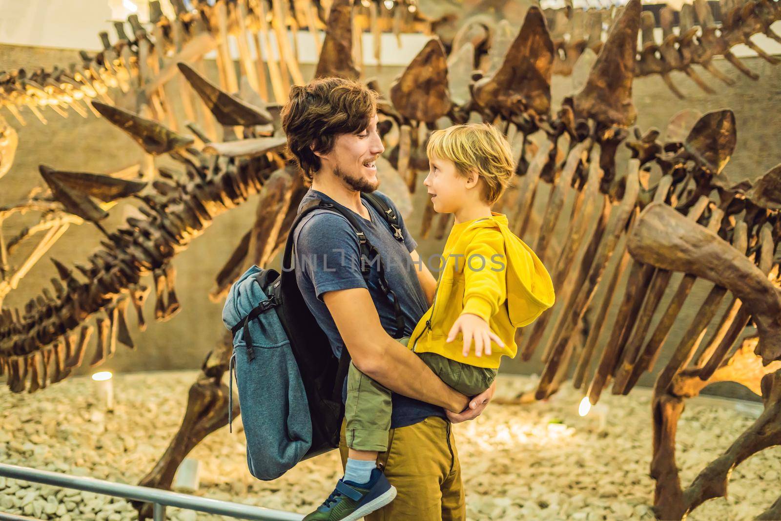 Beijing China, October 16, 2018: Dad and boy watching dinosaur skeleton in museum by galitskaya