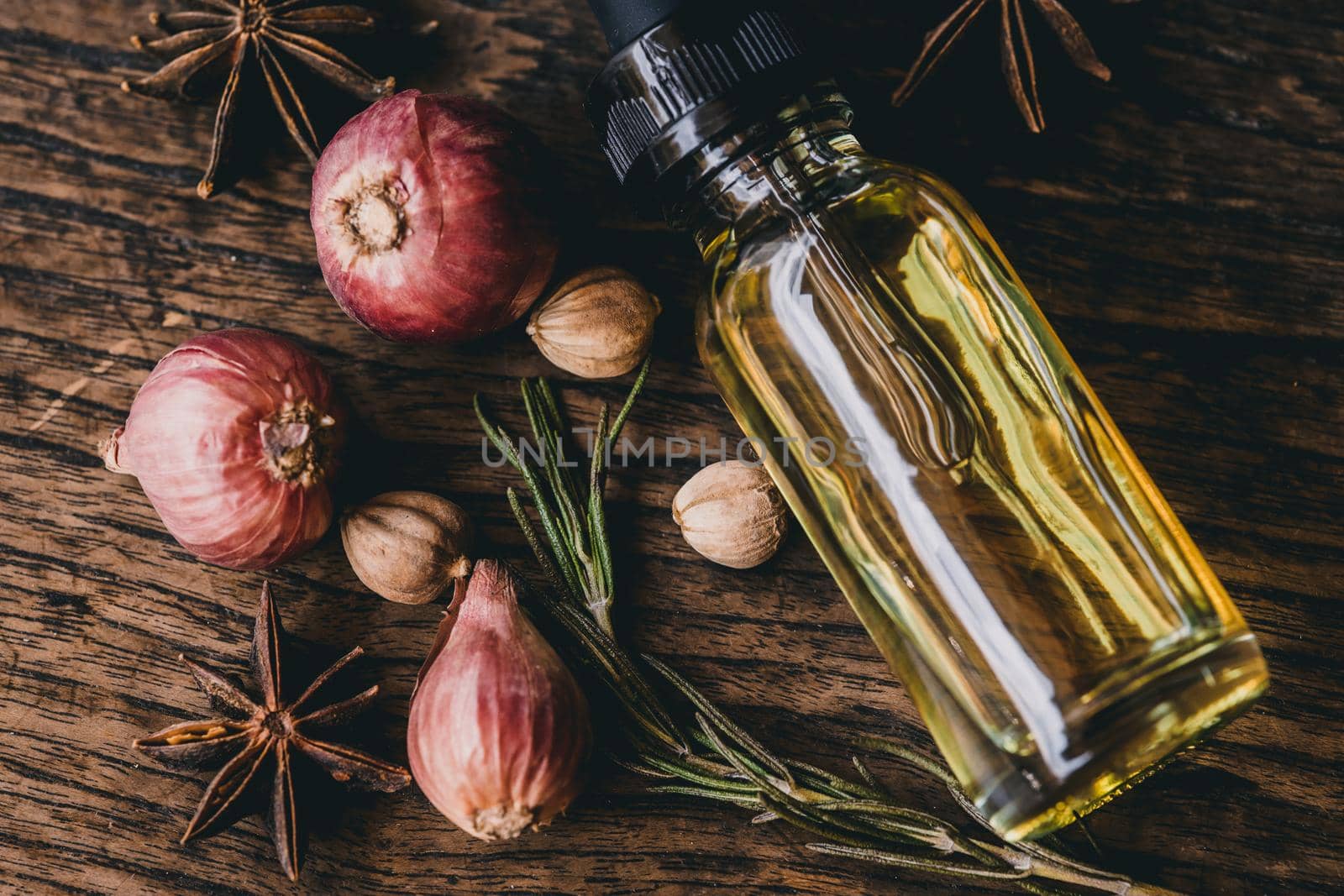 Herbal oil extract for food or aroma on wooden table decoration with scent herb. by qualitystocks