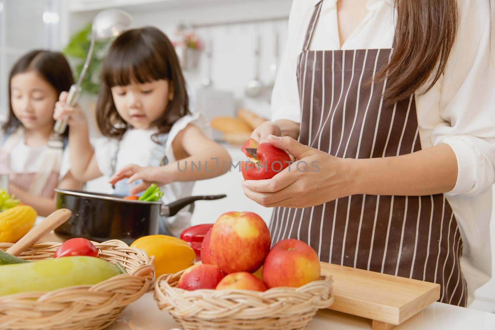 Mother and childs happy to preparing healthy food at home kitchen from vegetables and fruit