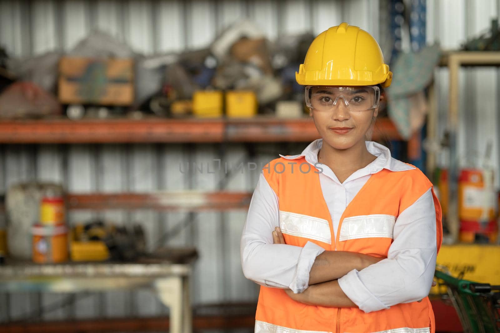 Portrait of smart women worker Asian race with protective safety suit standing smile by qualitystocks