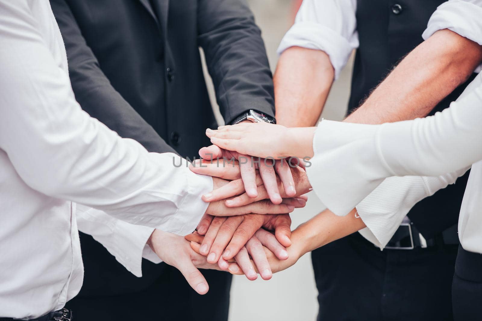 Closeup business people join hand together for unity teamwork group and diversity cooperation success team. by qualitystocks