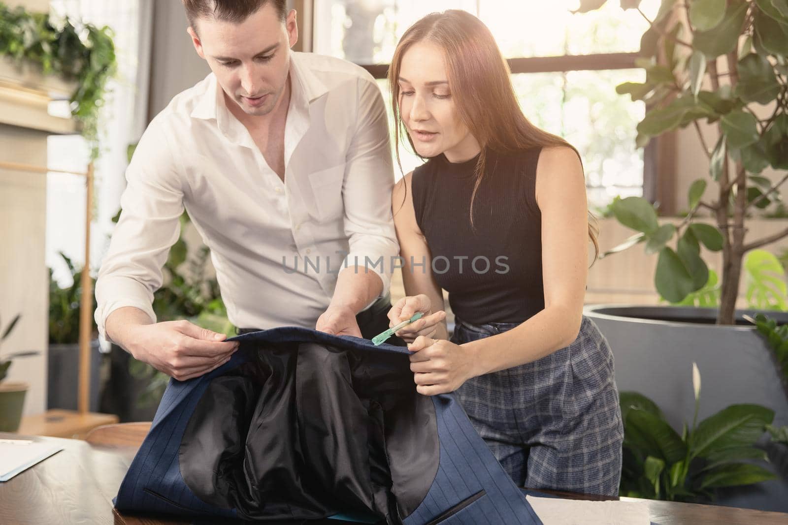 Men clothing designer, Working women co-working with man to design suit in tailor shop
