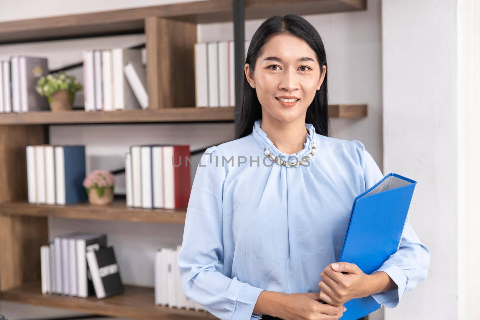 Asian business female women adult employee for accountant secretary or HR manager handle file folder. Portrait Thai middle age lawyer office worker professional look. by qualitystocks