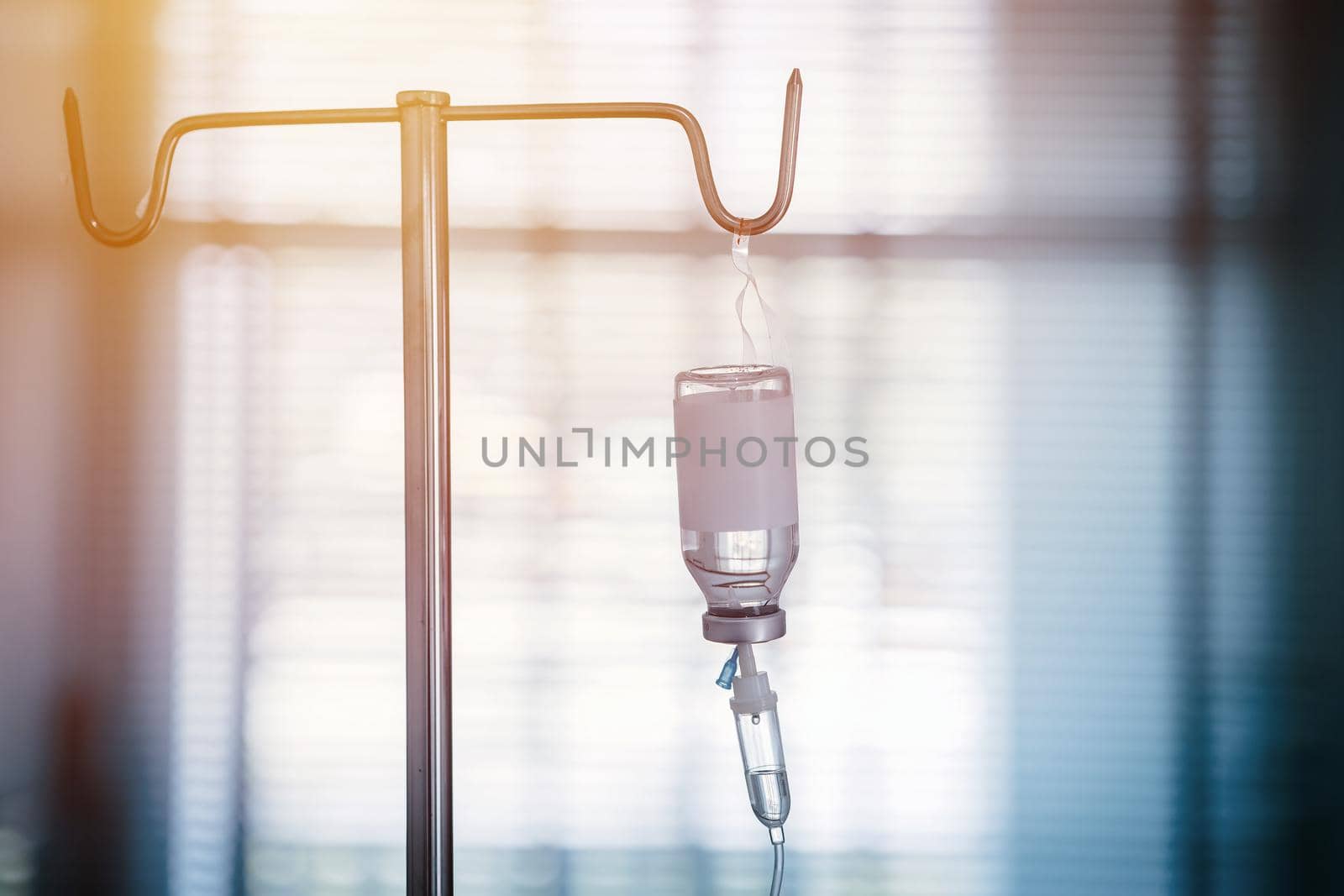 Intravenous Medication therapy or IV medicine bottle fluid drop saline drip in hospital ward, Emergency treatment injection drug infusion care chemotherapy blue light for Medical healthcare. by qualitystocks