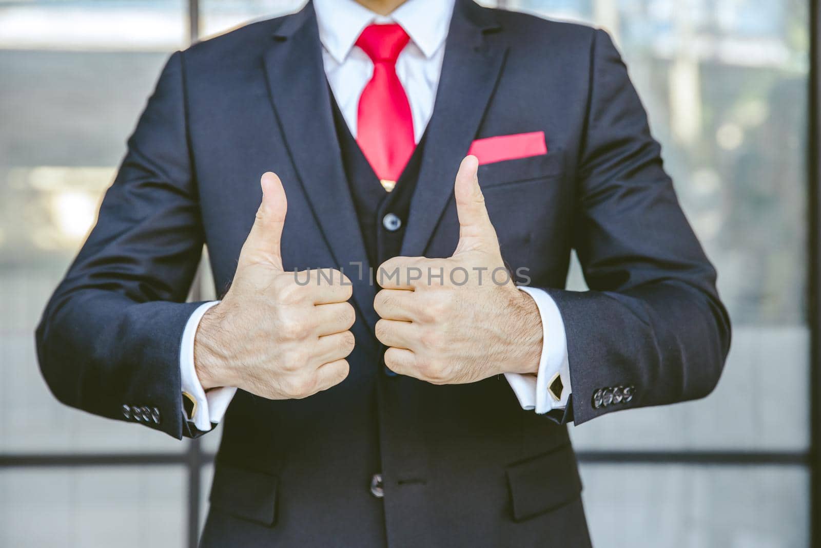 Two thumbs up business man close up at hand. male in suit show good best successful gesture.