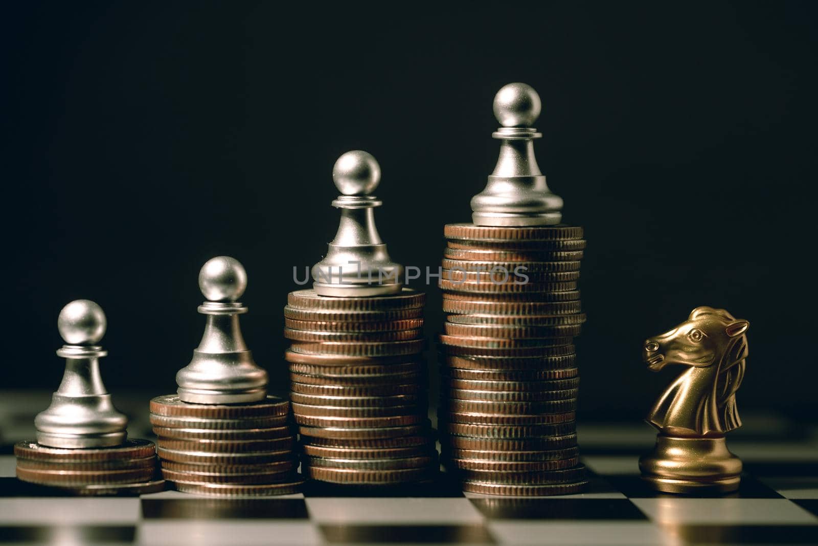 Good staff teamwork winner fighting concept, small Pawn chess piece on stacked coin against with Knight horse. by qualitystocks