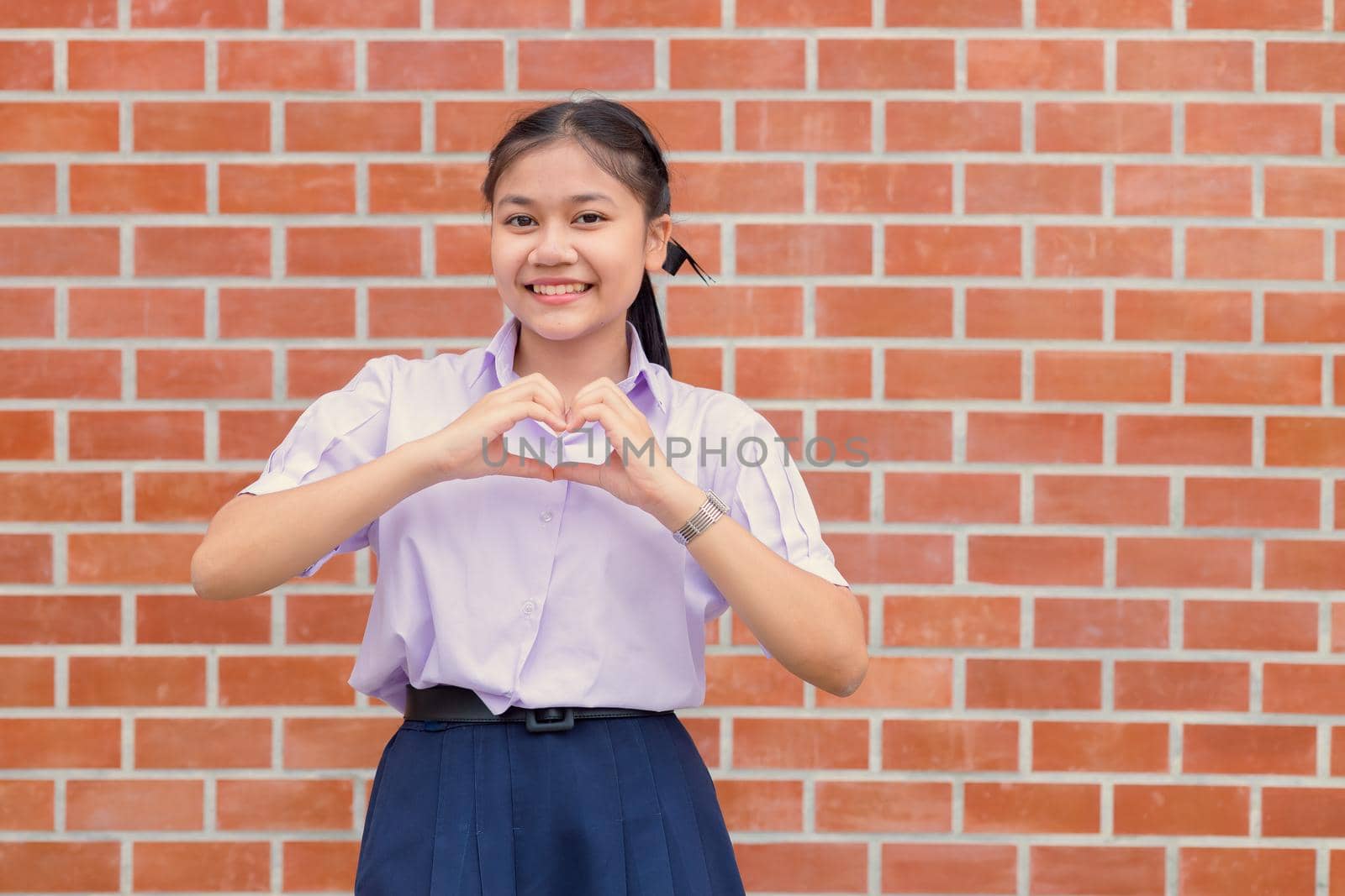 Asian Student Hand Love Heart Sign Gesture Portrait Happy Smiling. by qualitystocks