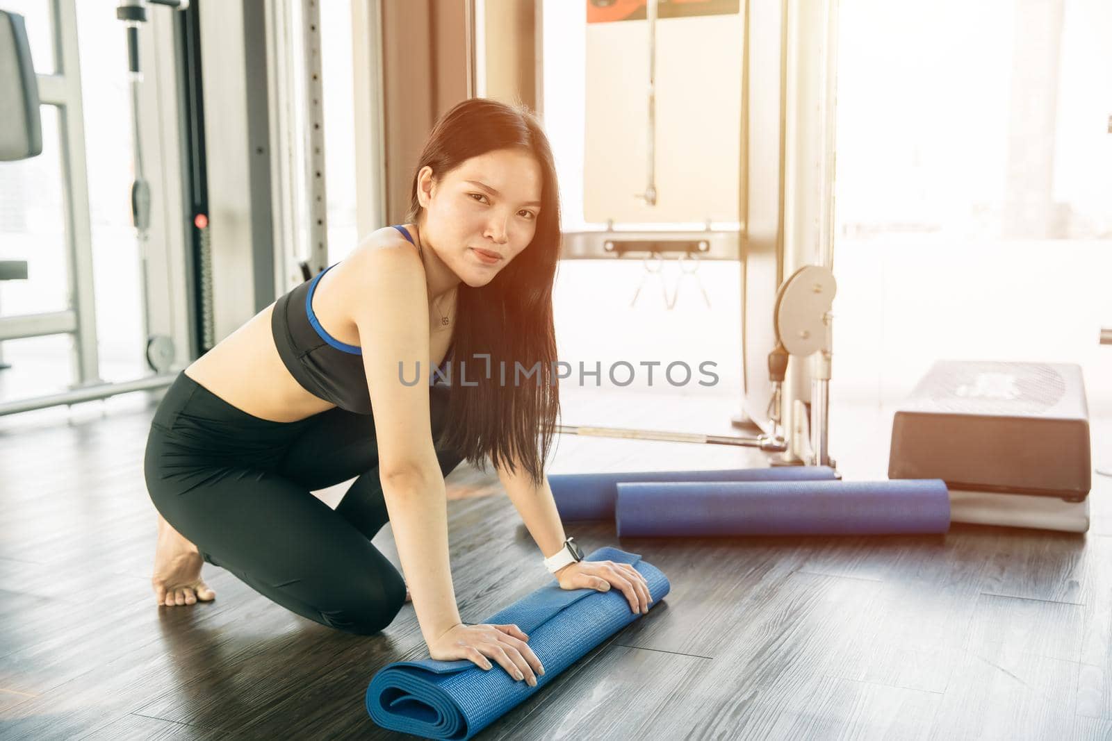 Portrait Sliming Asian women with Yoga mat workout in sport club happy smiling, Healthy lifestyle.