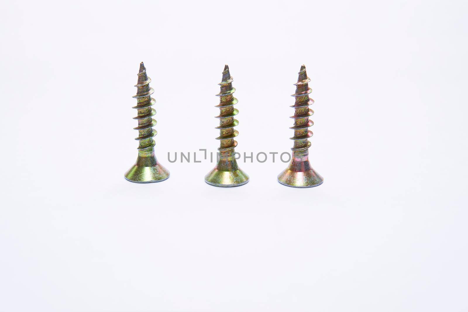 Three metal screws on a white background by jovani68