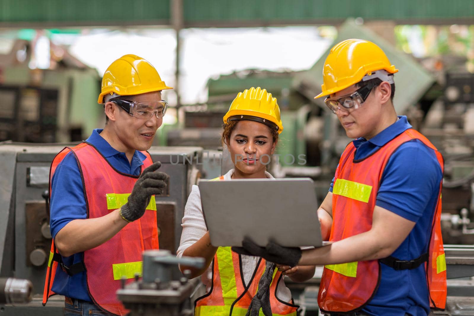 engineer women working with male team mix race work help together in heavy industry with laptop computer discussion, join partner good teamwork. by qualitystocks