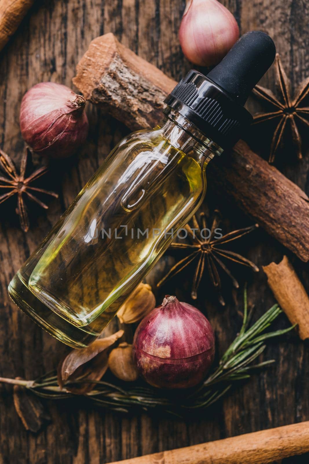 Closeup Essential oil extract from nature herbal and aroma dried herb vertical shot. by qualitystocks