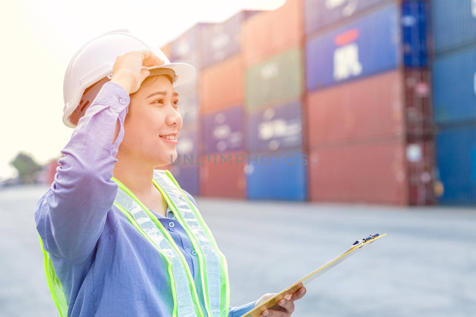 Asian working women happy to working in cargo port logistic goods transportation manager position proud expression. by qualitystocks